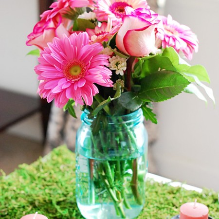 Pink flowers in blue mason jar
