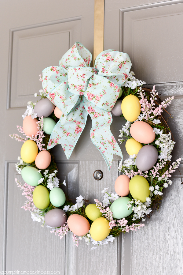 Easter Egg Wreath - create a beautiful Spring wreath with easter eggs, moss, and flowers. Add a pink and mint floral bow and you have a pretty DIY Easter egg wreath to welcome guests.