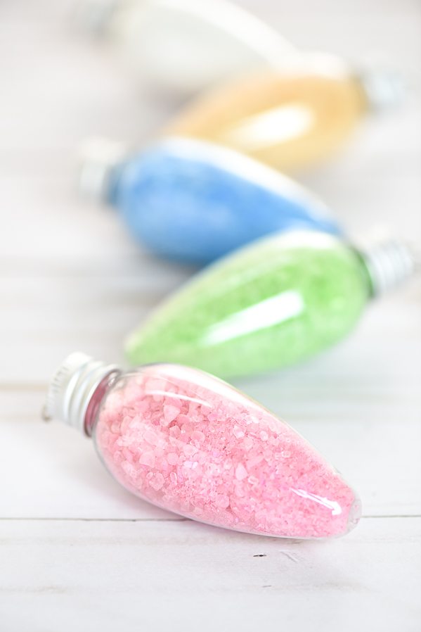 DIY Bath Salts Ornaments – these peppermint scented bath salts in Christmas light ornaments make a great handmade gift idea for under $5!