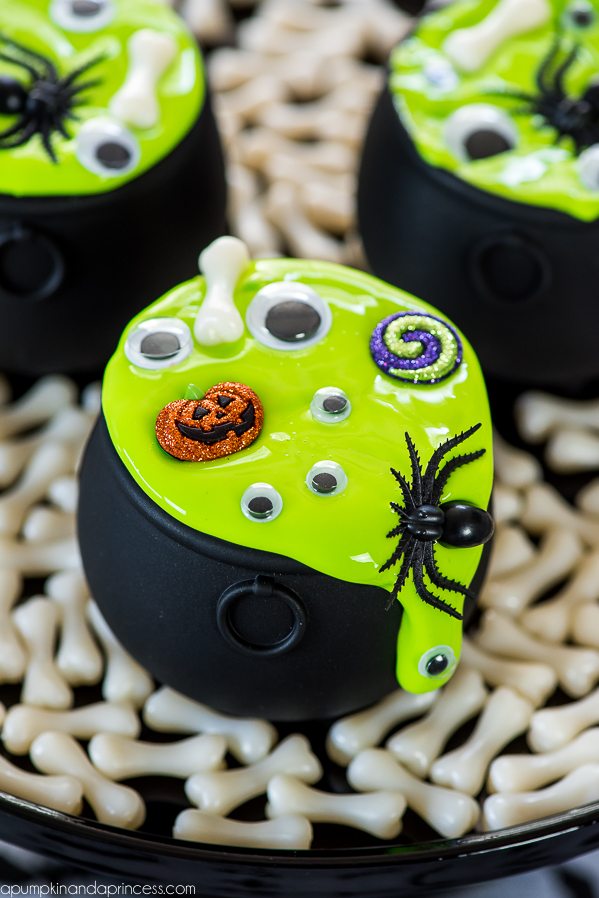 Cauldron Halloween slime party favors made with glow in the dark slime, eyes, pumpkins, spiders and bones!