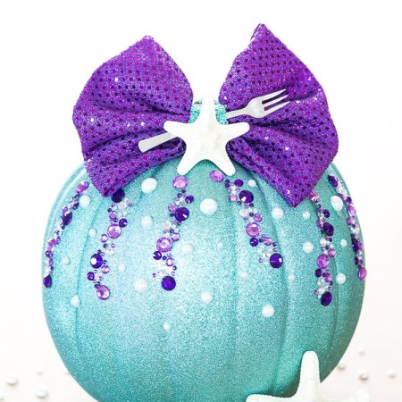 DIY No-Carve Little Mermaid Pumpkin – how to make a Disney Ariel inspired pumpkin with glitter, pearls, seashells and a mini fork to complete your under the sea creation.