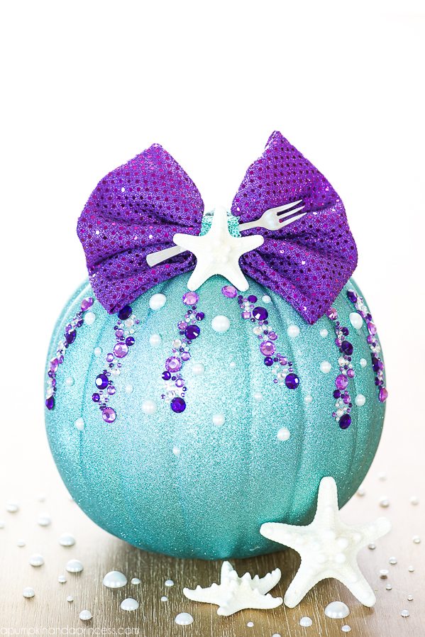 DIY No-Carve Little Mermaid Pumpkin – how to make a Disney Ariel inspired pumpkin with glitter, pearls, seashells and a mini fork to complete your under the sea creation.
