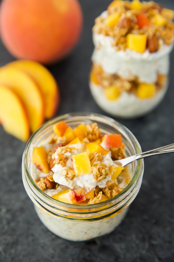 Overnight Oats topped with peaches, almond butter granola and honey