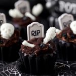 Halloween Cupcakes - chocolate graveyard cupcakes toped with white chocolate bones, cookie crumbs, and a tombstone.