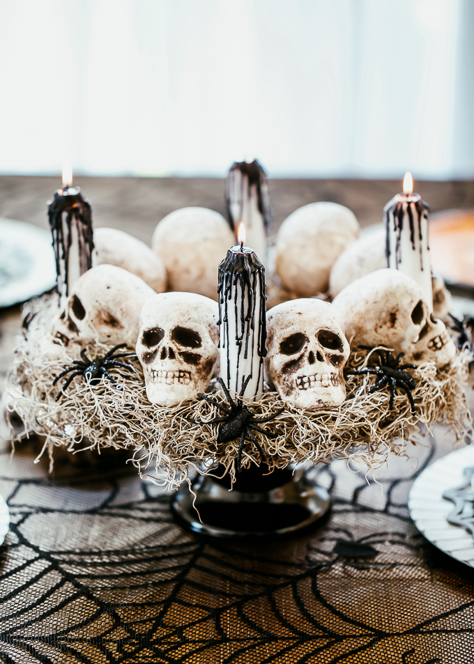 DIY Halloween skull centerpiece with white taper candles