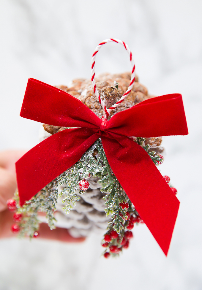 Red velvet bow on pinecone ornament