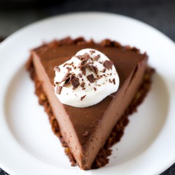 chocolate cream pie slice with whipped cream and chocolate shavings