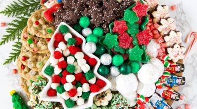 Christmas cookie dessert board with candy and fresh garland decoration