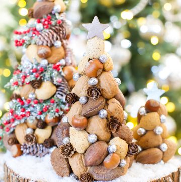 Paper mache Christmas trees made with nuts and pinecones