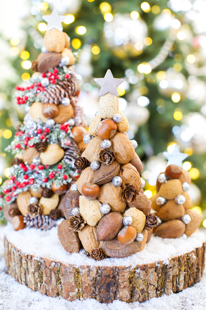 Paper mache Christmas trees made with nuts and pinecones