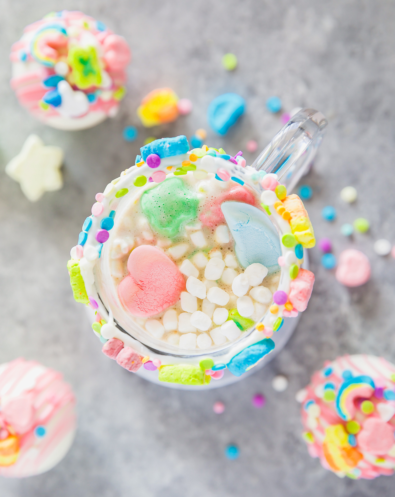 lucky charms marshmallows, white chocolate shell, and rich hot cocoa in a clear mug