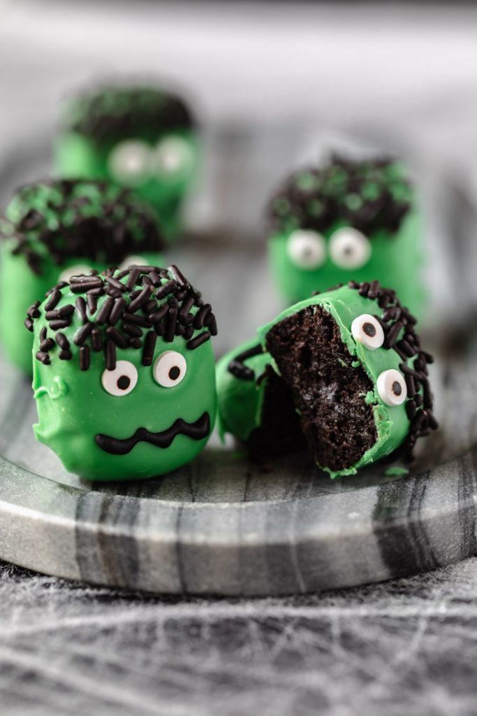 chocolate cookie truffle with green candy coating and eyes