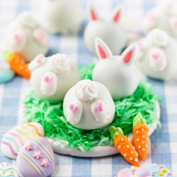 White chocolate covered oreo cookie balls decorated with icing bunny feet