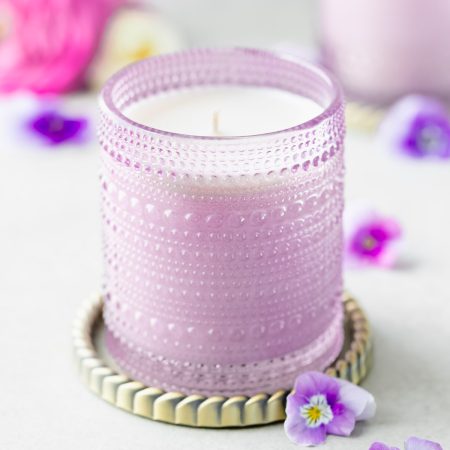 Spring floral scented soy candle in purple hobnail jar