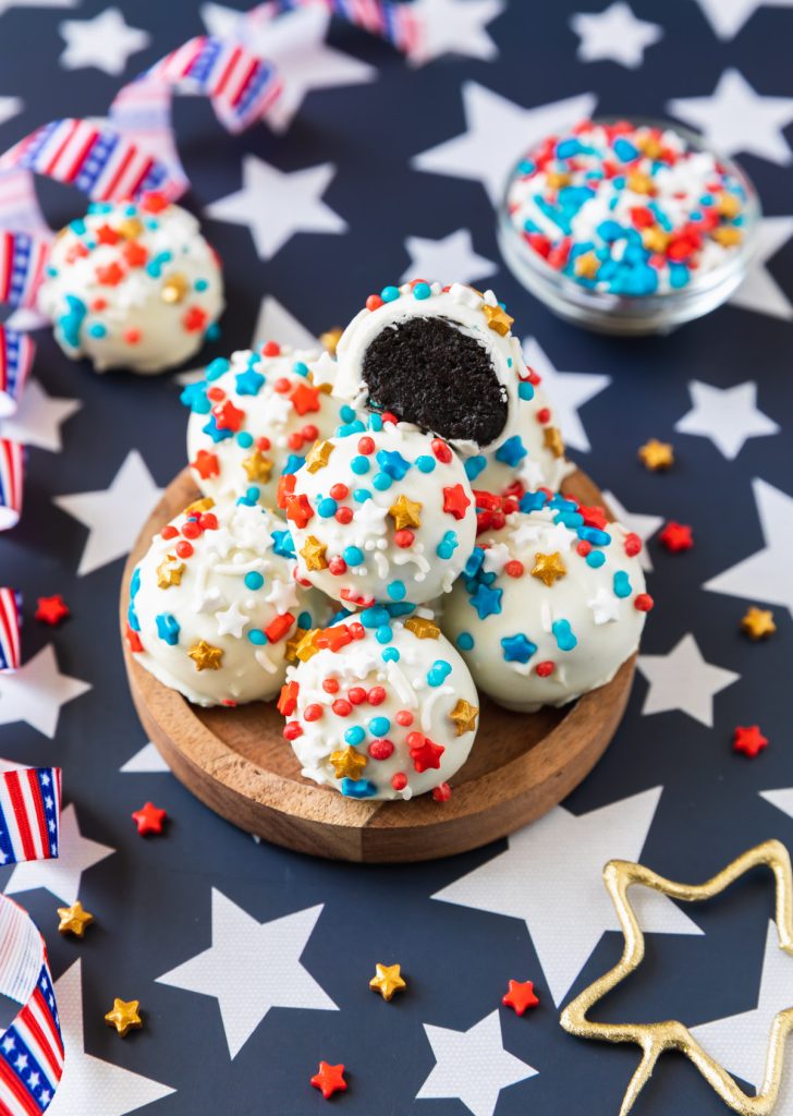 white chocolate covered oreo ball truffles with patriotic sprinkles