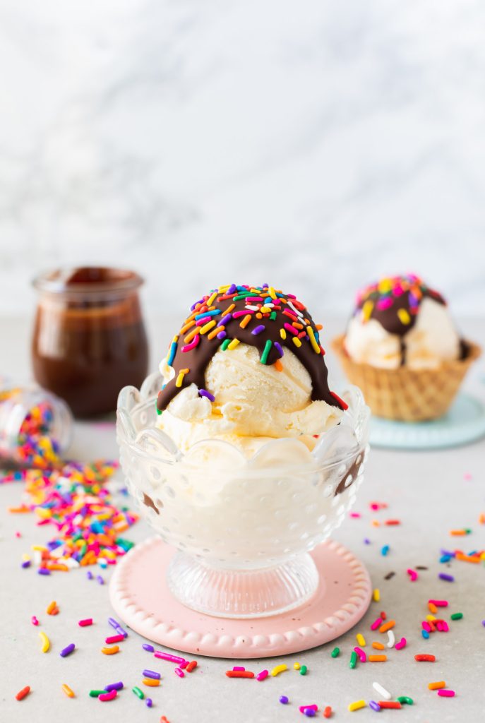 magic chocolate shell on vanilla ice cream scoop with sprinkles