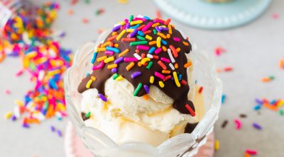 magic chocolate shell topping on vanilla ice cream with rainbow sprinkles