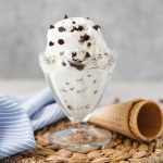 chocolate chip ice cream scoop in glass sundae cup