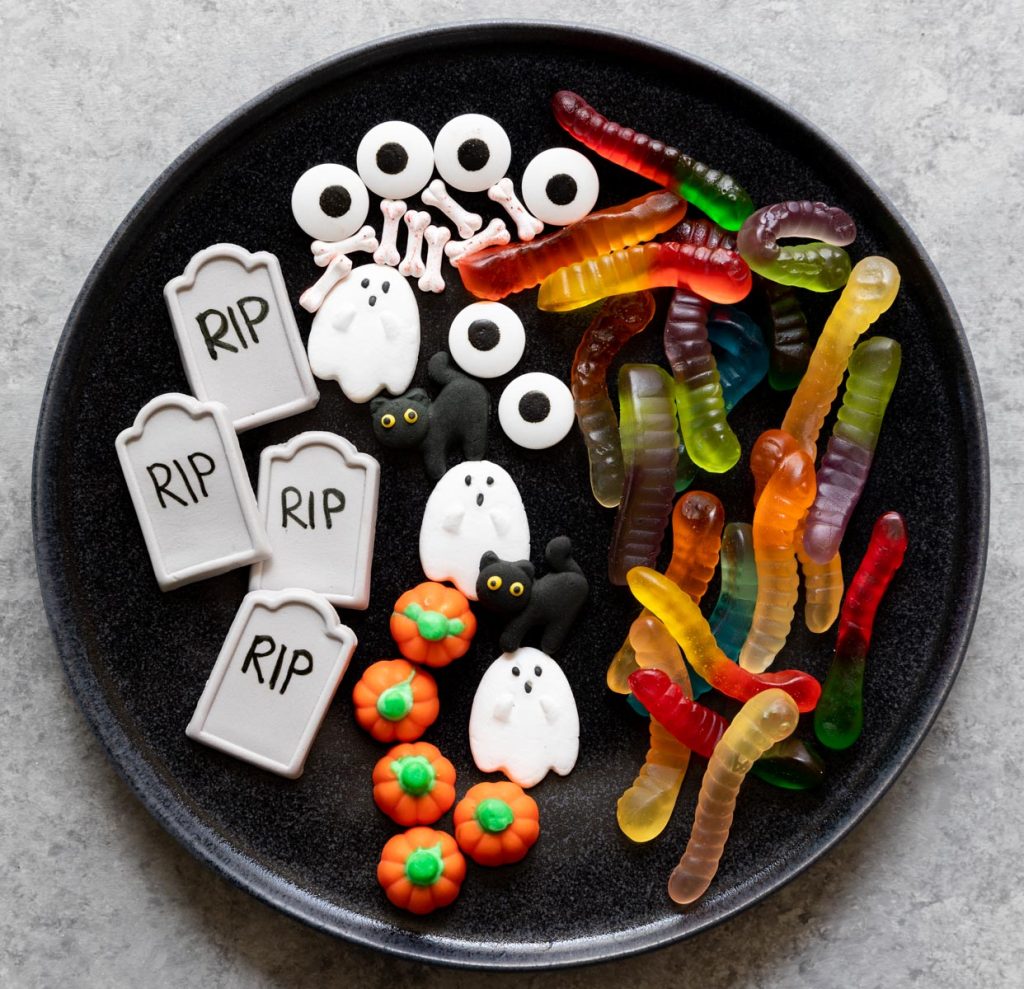 Halloween candy ghosts, pumpkins, tombstones, gummy worms, and eyes