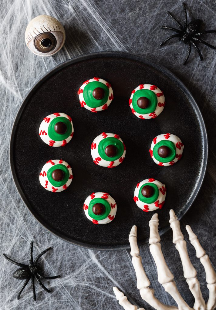 eyeball shaped Halloween oreo balls with green eyes and red veins
