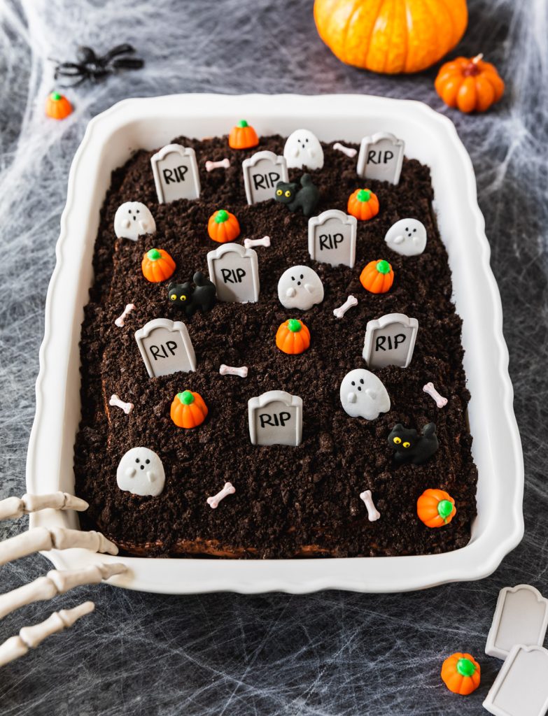 Chocolate cake decorated with Oreo cookie crumbs and Halloween candy