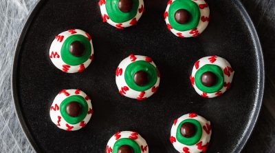 white chocolate covered oreo balls with green eyes and red veins