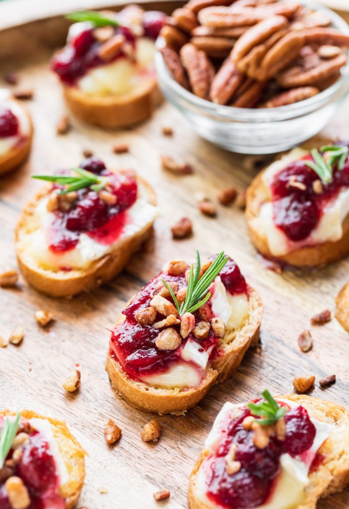 toasted bread slices topped with creamy brie and cranberry sauce