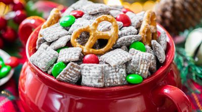red and green Christmas M&M's muddy buddies in red bowl