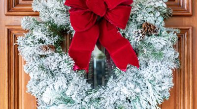 faux snow flocked wreath with red bow for Christmas