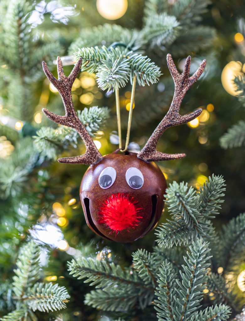 brown bell ornament with red pom pom and glitter antlers
