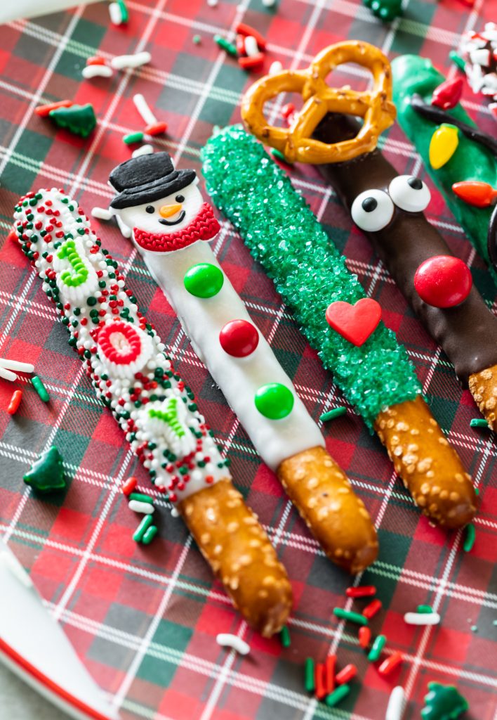 holiday pretzels decorated into snowmen, Grinch pretzels, and Reindeer pretzels