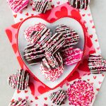 chocolate-covered heart-shaped oreo ball truffles with sprinkles