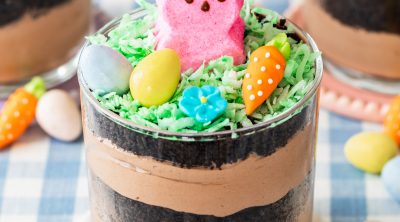 Easter dirt cups made with chocolate pudding, bunny marshmallows, and Cadbury mini eggs