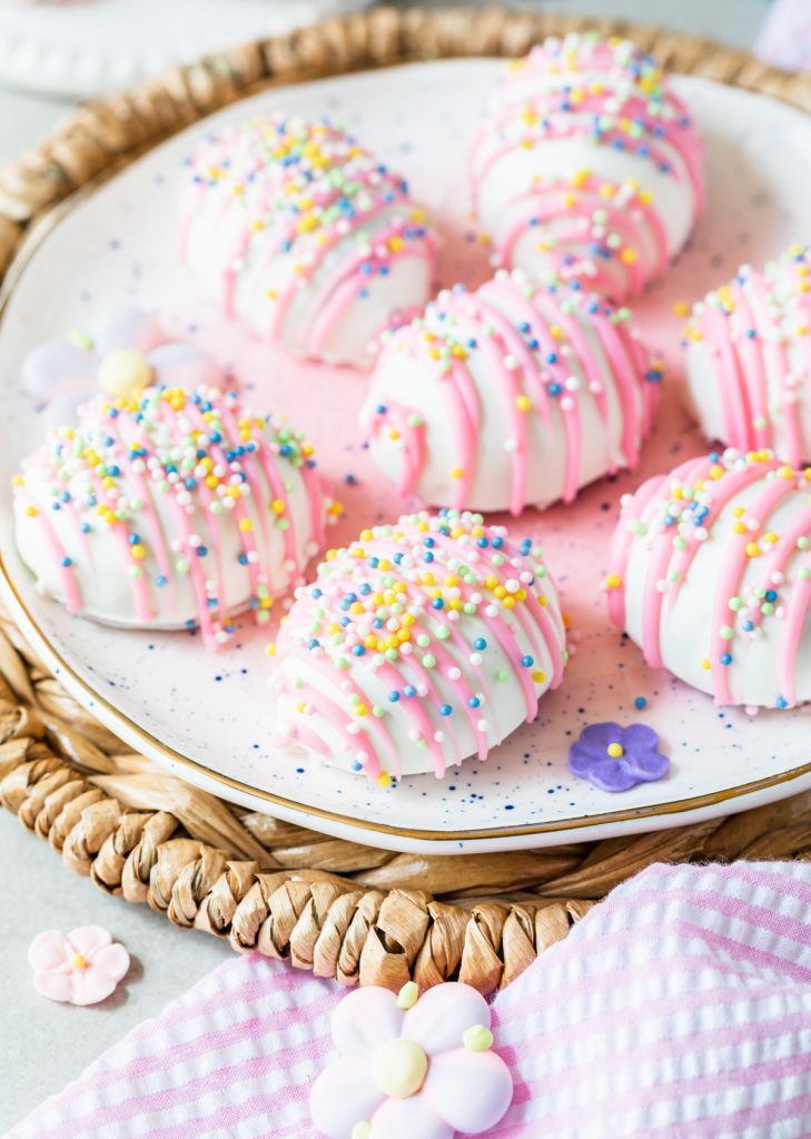 white chocolate covered egg-shaped oreo truffle decorated with Easter sprinkles