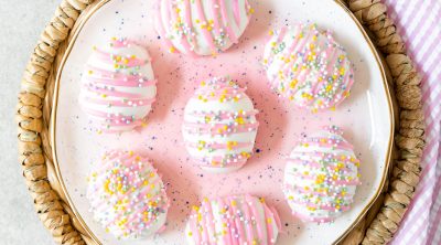 Festive Easter egg shaped Oreo balls with pink chocolate drizzle and sprinkles