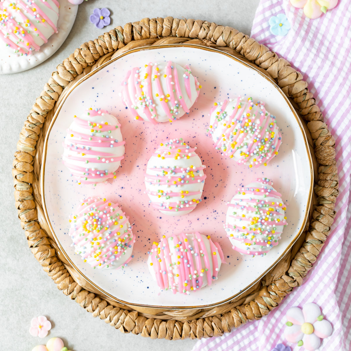 Festive Easter egg shaped Oreo balls with pink chocolate drizzle and sprinkles